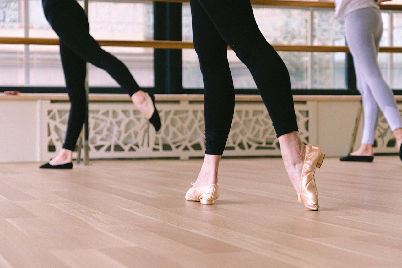 Ballet dancers practicing graceful moves in a serene studio environment.